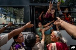 Activists who had come to support of protesting wrestlers are detained by the police as they try to join them in a march towards the newly inaugurated parliament, in New Delhi, India, May, 28, 2023.