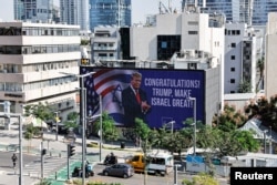 Republican presidential nominee and former U.S. President Donald Trump appears on a congratulatory billboard for the 2024 U.S Presidential Election, in Tel Aviv, Israel, Nov. 6, 2024.