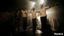 Malian band Songhoy Blues members, Nathanael Dembele (L-R), Garba Toure, Aliou Toure and Oumar Toure, react at the end of their concert at Village Underground in London, May 28, 2015. 