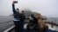Holidaymakers take a selfie, along with Star Wars fans dressed in costume as Darth Vader and Chewbacca, on a boat trip to Skellig Island during the inaugural "May The 4th Be With You" festival in the County Kerry village of Portmagee, Ireland, May 4, 2018