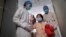 A girl, who was previously infected with the H7N9 bird flu virus, waves as she is being transferred to a public ward from the ICU at Ditan hospital in Beijing, Apr. 15, 2013.