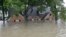 A flooded home is shown as floodwaters from Tropical Storm Harvey rise, Aug. 28, 2017, in Spring, Texas. 