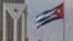 (FILE) Cuban and American flags fly in the wind outside the American embassy in Havana, Cuba, Tuesday, Jan.14, 2025.