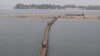 A wooden bridge connects to a sand island along the Mekong River, in Sambor district, Kratie province, March 11, 2020. (Sun Narin/VOA Khmer) 