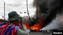 A person is seen near to a fire during a protest in Senkata, El Alto, Bolivia, Nov. 19, 2019. 