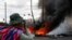 A person is seen near to a fire during a protest in Senkata, El Alto, Bolivia, Nov. 19, 2019. 