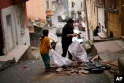 Residents gather pieces of wood to burn for heat in the Tarlabasi neighborhood in Istanbul, Turkey, Dec. 4, 2024.