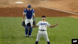 Los Angeles Dodgers starting pitcher Julio Urias celebrates their win against the Atlanta Braves in Game 7 of a baseball National League Championship Series, Oct. 18, 2020, in Arlington, Texas.