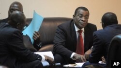 The representative of Ivorian incumbent President Laurent Gbagbo, Pascal N'guessan (C), speaks with members of his delegation on March 10, 2011 before the start of African Union talks in Addis Ababa