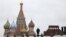 FILE - A man walks along Red Square, with the mausoleum of Soviet state founder Vladimir Lenin, right, and St. Basil's Cathedral seen in the background, in central Moscow, Russia, Dec. 21, 2015. 