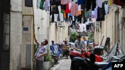 People are seen in their neighborhood in the Jing'an district of Shanghai on June 2, 2022, following the easing of COVID-19 restrictions in the city after a two-month lockdown. 