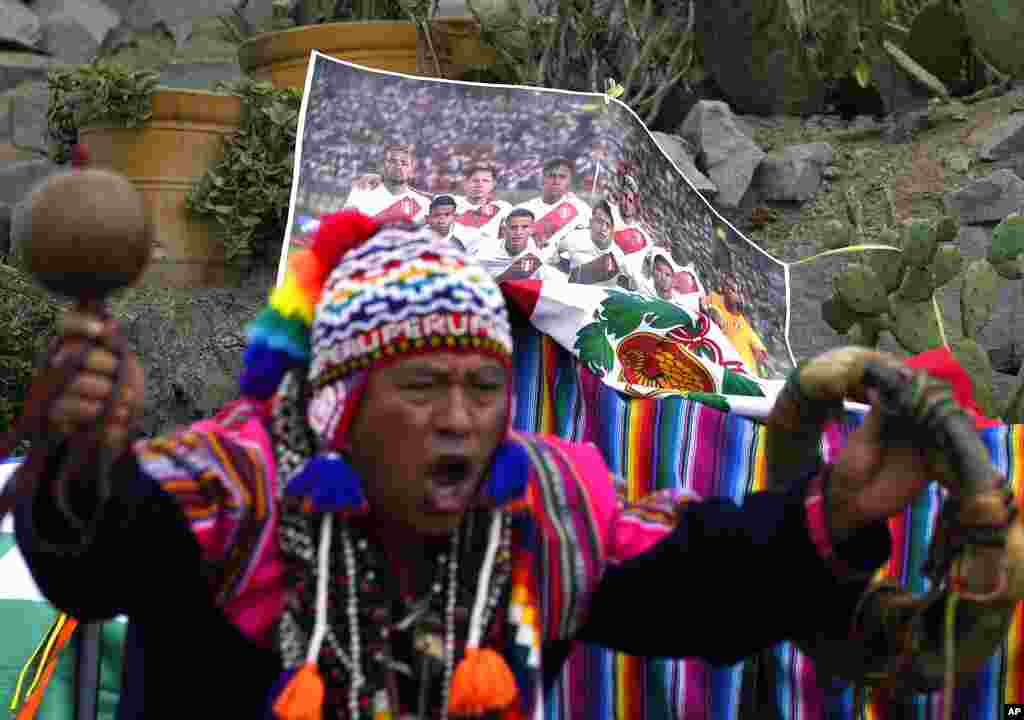 A shaman performs a good luck ritual in front of a photo of Peru&#39;s national soccer team, on San Cristobal hill in Lima, Peru.&nbsp;(AP Photo/Martin Mejia)