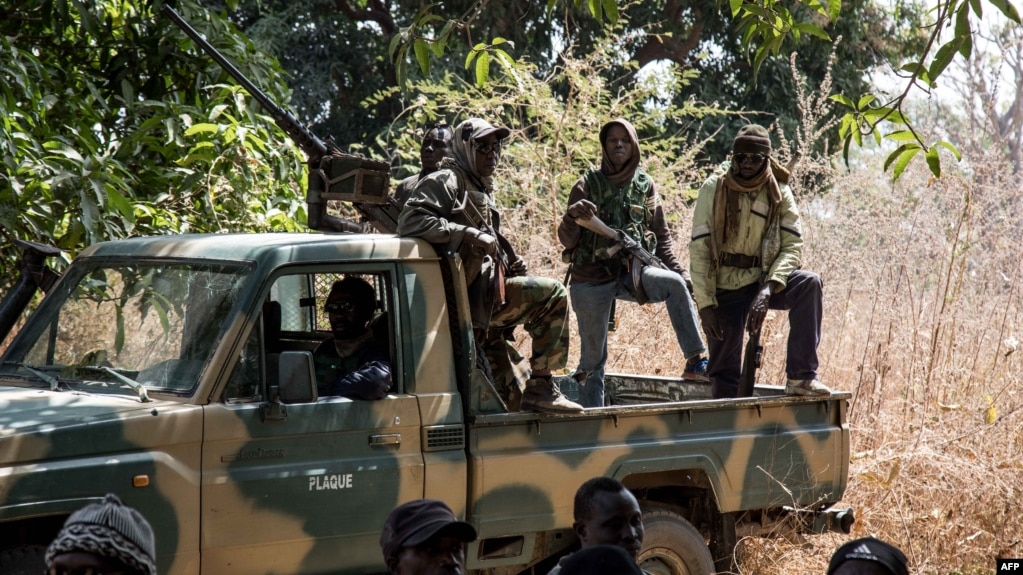 Separatists belonging to the Movement of Democratic Forces of Casamance look on during the release of seven captured Senegalese soldiers at an abandoned settlement, Baipal in Gambia on February 14, 2022. 