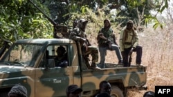FILE - Separatists belonging to the Movement of Democratic Forces of Casamance look on during the release of seven captured Senegalese soldiers at an abandoned settlement, Baipal, in Gambia, Feb. 14, 2022. 