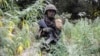 A member of the Senegalese Armed Forces walks through a field of marijuana at a captured Movement of Democratic Forces of Casamance rebel base in Blaze Forest on February 9, 2021. 