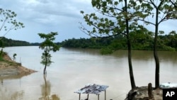 FILE - The Itaquai River runs through the Vale do Javari region in Amazonas state, Brazil, June 16, 2021, on the border with Peru.