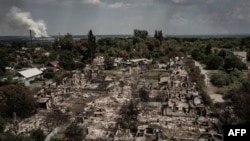 An aerial view shows destroyed houses after strike in the town of Pryvillya at the eastern Ukrainian region of Donbas, June 14, 2022. The cities of Sievierodonetsk and Lysychansk, which are separated by a river, have been targeted for weeks.