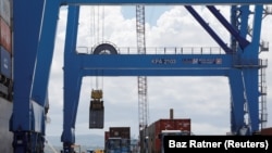 FIKLE: A crane loads shipping containers on a ship in the port of Mombasa, Kenya. Taken Oct. 23, 2019.