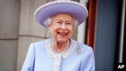 Queen Elizabeth II watches from the balcony of Buckingham Palace after the Trooping the Color ceremony in London, June 2, 2022.