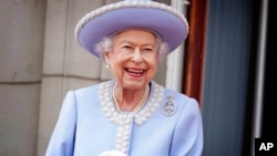 Queen Elizabeth II watches from the balcony of Buckingham Palace after the Trooping the Color ceremony in London, June 2, 2022.