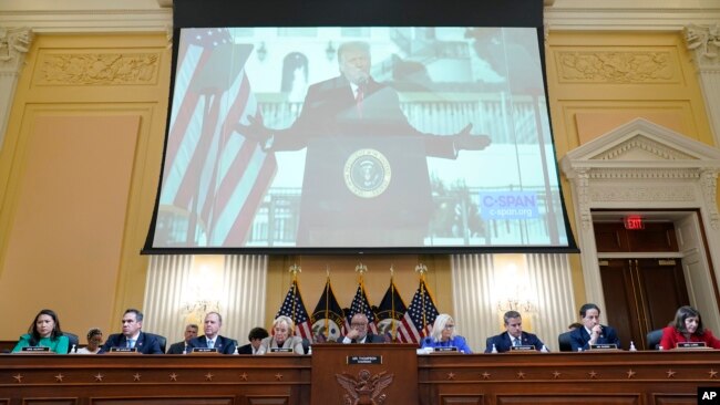 A video of former President Donald Trump speaking during a rally near the White House on Jan. 6, 2021, is shown as committee members from look on during a public hearing of the House select committee investigating the attack, June 9, 2022