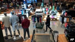 File: Shoppers shop at a retail store in Niles, Ill., on Feb. 19, 2022. U.S. inflation has dropped to its lowest level since before 2022