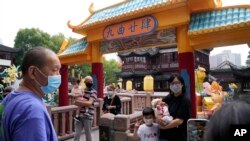 Residents wearing masks visit Yu Garden Mall, June 2, 2022, in Shanghai, the day after the easing of a strict two-month COVID-19 lockdown.