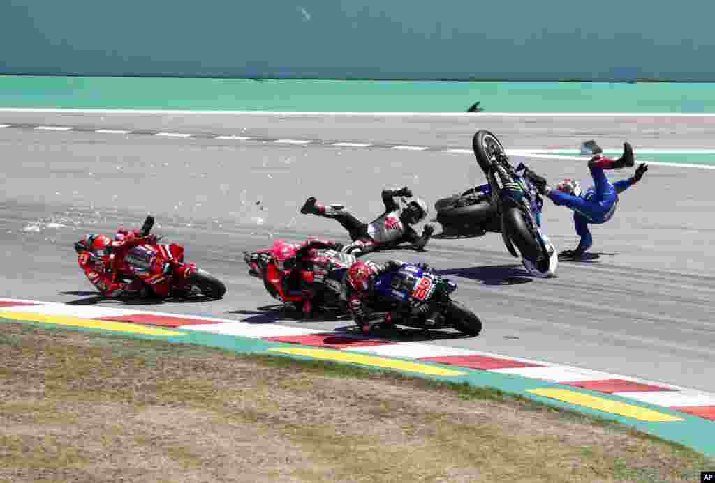 Spain&#39;s rider Alex Rins of the Team SUZUKI ECSTAR, top right, and Japan&#39;s rider Takaaki Nakagami of the LCR Honda IDEMITSU and Italian rider Francesco Bagnaia of the Ducati Lenovo Team, left, fall during the MotoGP race of the Catalunya Motorcycle Grand Prix at&nbsp;t the Catalunya racetrack in Montmelo, just outside of Barcelona, Spain.