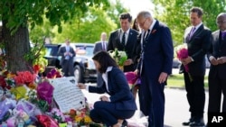 File - New York Gov. Kathy Hochul looks at a memorial at the scene of a shooting at a supermarket in Buffalo, N.Y., Tuesday, May 17, 2022, in response to gun violence, Hochul signed 10 gun control bills into law on Monday.
