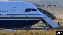 FILE: A Boeing 767 sits on the runway at the military base in Amesbury, Salisbury, on 6.14.2022 preparing to take a number of asylum-seekers to Rwanda. The deportation flight was halted by court action. 