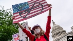 Activists join Senate Democrats outside the Capitol in Washington, to demand action on gun control legislation after a gunman killed 19 children and two teachers at a Texas elementary school, May 26, 2022.