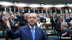 Turkish President Tayyip Erdogan greets members of his ruling AK Party (AKP) during a meeting at the parliament in Ankara, Turkey May 18, 2022. (Handout photo via Reuters)