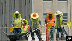 Workers brave the oppressive heat in Jackson, Mississippi, as they reroof the Barfield Complex, June 13, 2022, during a heat wave through much of the Midwest and South.