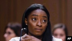 FILE - United States Olympic gymnast Simone Biles testifies during a Senate Judiciary hearing about the Inspector General's report on the FBI's handling of the Larry Nassar investigation on Capitol Hill, Sept. 15, 2021, in Washington. 