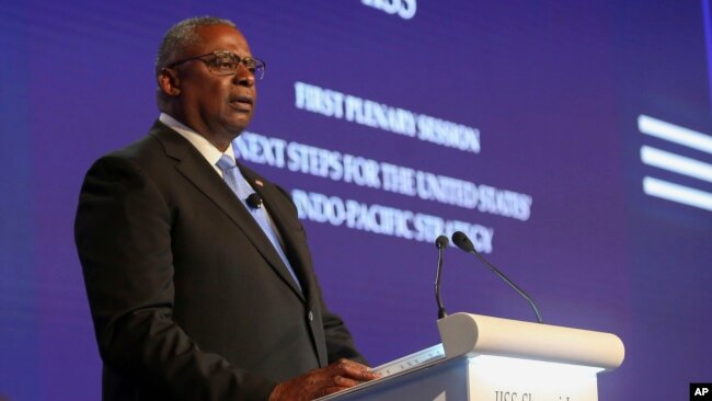 FILE - U.S. Defense Secretary Lloyd Austin speaks at the 19th International Institute for Strategic Studies Shangri-la Dialogue, in Singapore, June 11, 2022. Austin contracted COVID-19 for the second time this year and has mild symptoms.