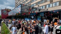 People lineup to visit a newly opened fast food restaurant in a former McDonald's outlet in Bolshaya Bronnaya Street in Moscow, Russia, June 12, 2022. 