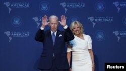 U.S. President Joe Biden, accompanied by first lady Jill Biden, waves as he arrives to greet leaders during the Summit of the Americas, in Los Angeles, California, June 8, 2022.