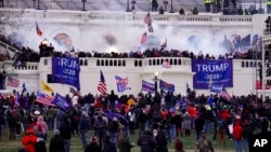 FILE - Supporters of President Donald Trump storm the Capitol, Jan. 6, 2021, in Washington.