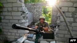 A Ukrainian serviceman keeps his position not far from the Ukrainian town of Chuguiv, in Kharkiv region on June 9, 2022.
