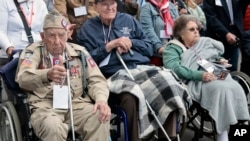 US WWII veteran Ray Wallace, of the 507th PIR 82rd Airborne, looks on as World War II history enthusiasts parade in WWII vehicles to commemorate the 78th anniversary of D-Day that led to the liberation of France and Europe from the German occupation, in S