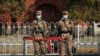 Chinese military personnel guard a road near the Tiananmen area where China's annual legislature meetings are held on March 8, 2022, in Beijing.