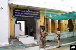 Policemen stand guard at the mausoleum of 17th century Mughal emperor Aurangzeb in Aurangabad, India, May 20, 2022.