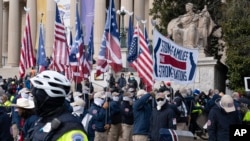 FILE - Members of the white supremacist group Patriot Front demonstrate near the National Archives in Washington, Jan. 21, 2022.