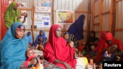 FILE - Internally displaced Somali women carry their children as they wait for malnutrition screening at the Dollow hospital in Dollow, Gedo Region, Somalia, May 24, 2022.