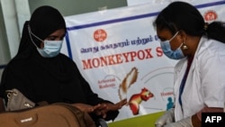 Health workers screen passengers arriving from abroad for monkeypox symptoms at Anna International Airport terminal in Chennai, India, June 3, 2022. 