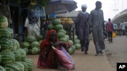 FILE - A woman begs on a street in N'Djamena, Chad, April 26, 2021.