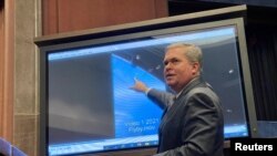 FILE - Deputy Director of U.S. Naval Intelligence Scott Bray points to a video of a "flyby" as he testifies about "Unidentified Aerial Phenomena," in the first open congressional hearing on UFOs in more than half-century, on Capitol Hill in Washington, May 17, 2022.