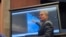FILE - Deputy Director of U.S. Naval Intelligence Scott Bray points to a video of a "flyby" as he testifies about "Unidentified Aerial Phenomena," in the first open congressional hearing on UFOs in more than half-century, on Capitol Hill in Washington, May 17, 2022.