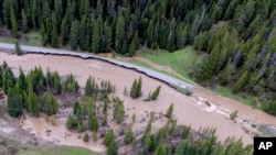 This aerial photo provided by the National Park Service shows a flooded out North Entrance Road, of Yellowstone National Park in Gardiner, Montana, on June 13, 2022. 