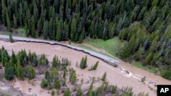 Jalan Masuk Utara Taman Nasional Yellowstone yang terendam banjir di Gardiner, Montana., pada 13 Juni 2022. (Foto: via AP)